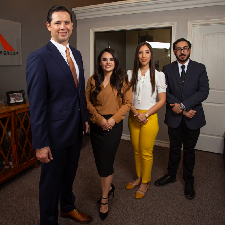 four staff members at the Agustin Hernandez Law Firm standing in the lobby